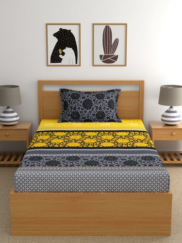 https://cdn.shopify.com/s/files/1/1857/6931/products/8e37ab07-9694-4591-bbde-5e929ca26fa41694485508807DreamscapeYellowBlackEthnicMotifs140TCSingleBedsheetwith1Pil2.jpg?v=1703241843